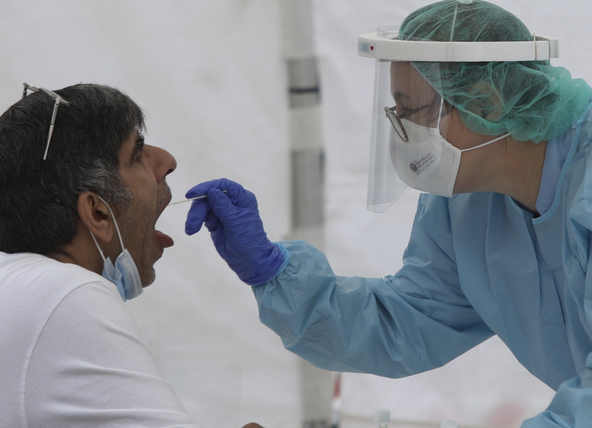 Una sanitaria le realiza un frotis bucal a un vecino de Ordizia en una de las carpas instaladas en el parque Barrena por el Ayuntamiento de Ordizia para realizar test ante el posible brote de COVID-19