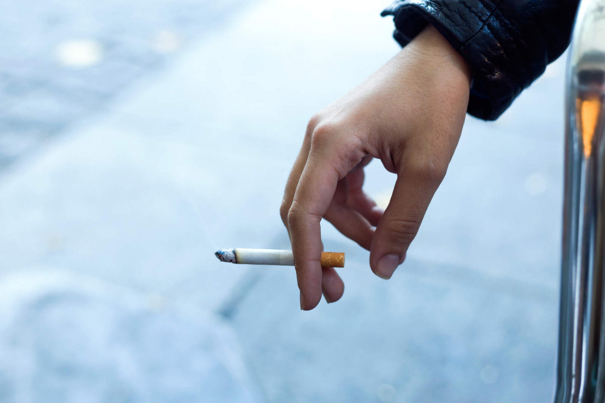 Womans hand with cigarette street 1600 1067