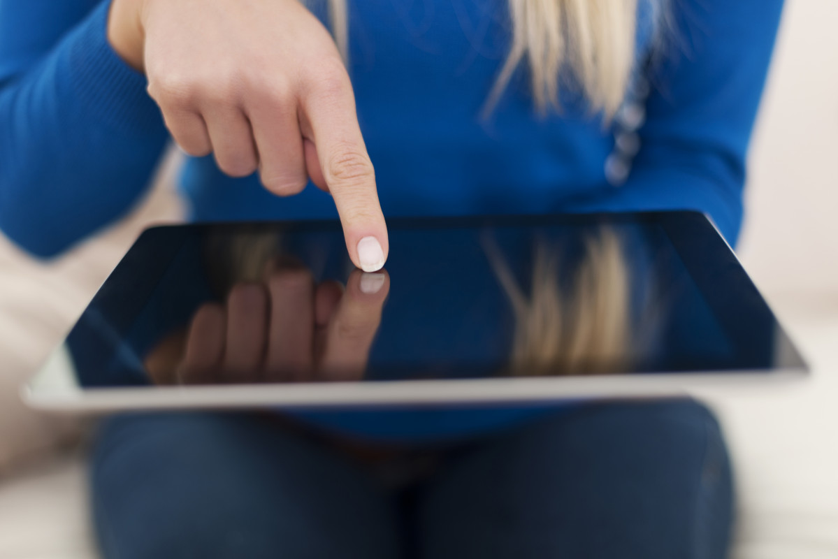 Close up woman using digital tablet