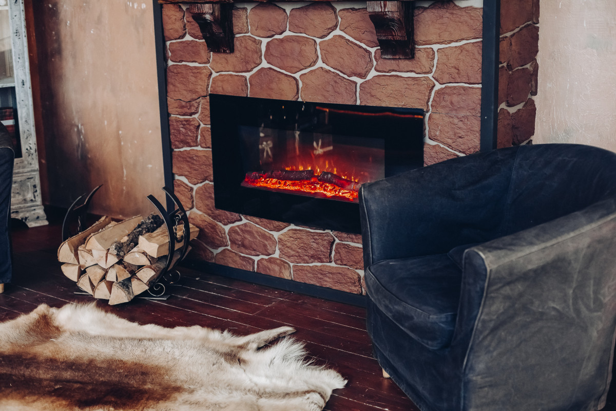 View fireplace with burning logs natural fur skin floor holder with logs cozy room