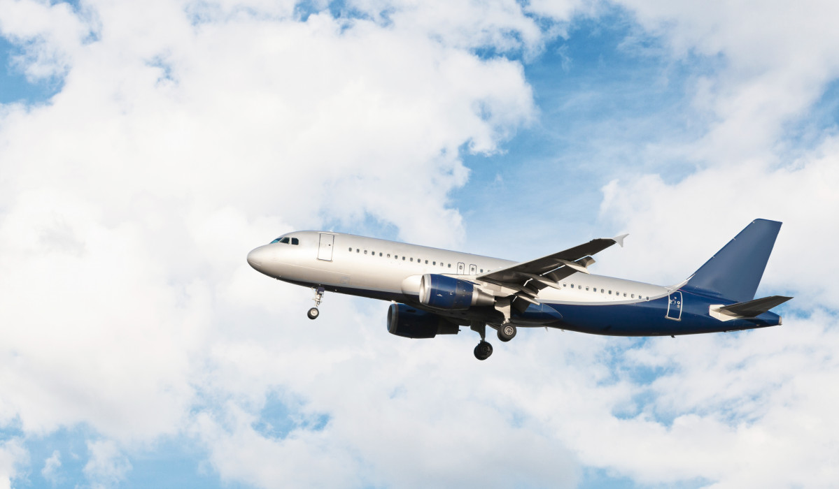 Airplane flying cloudy sky