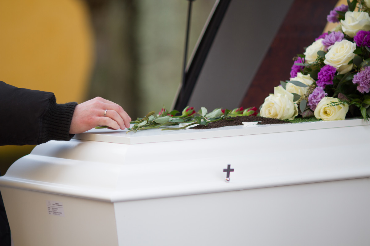 Closeup shot person hand casket with blurred background