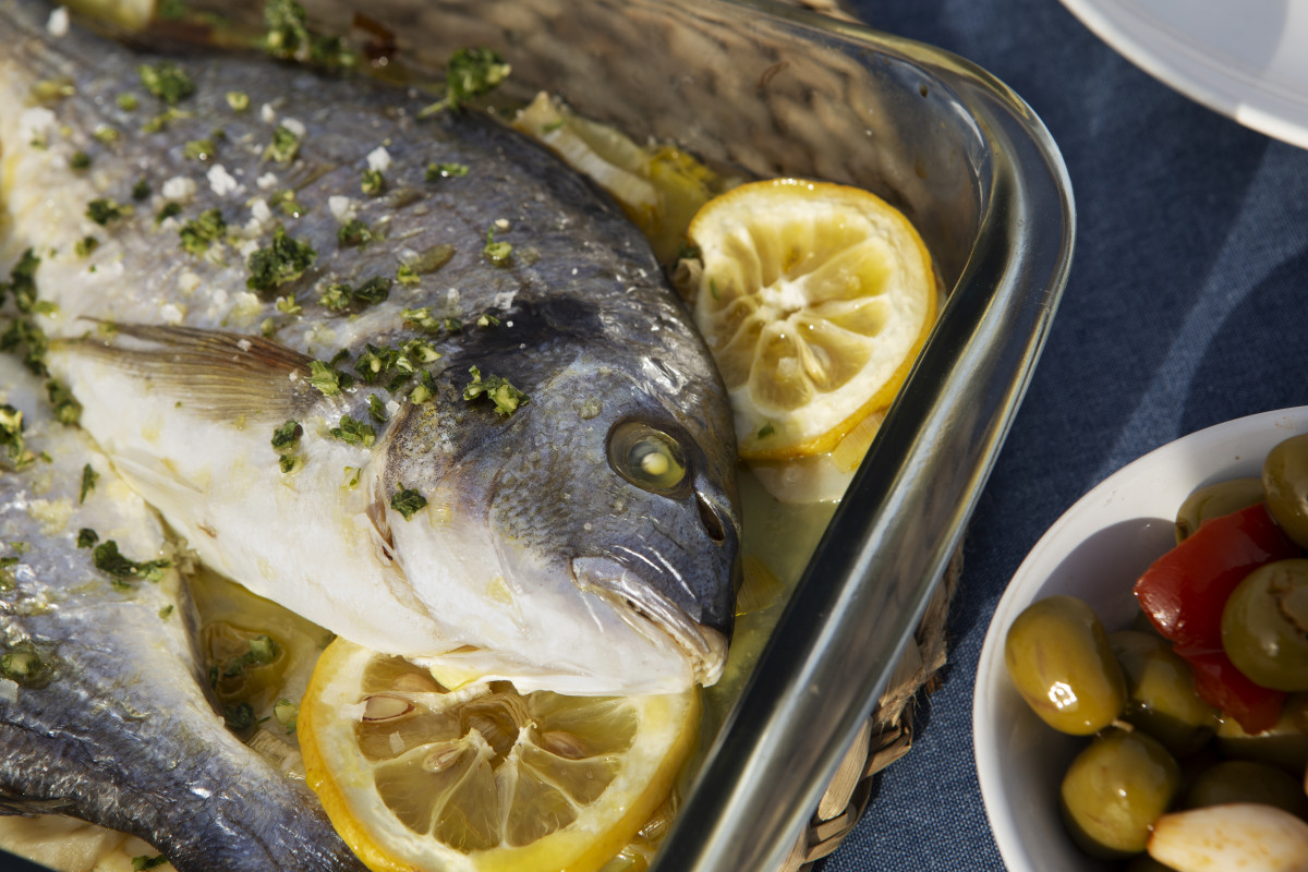 Tasty seabream with lemons high angle