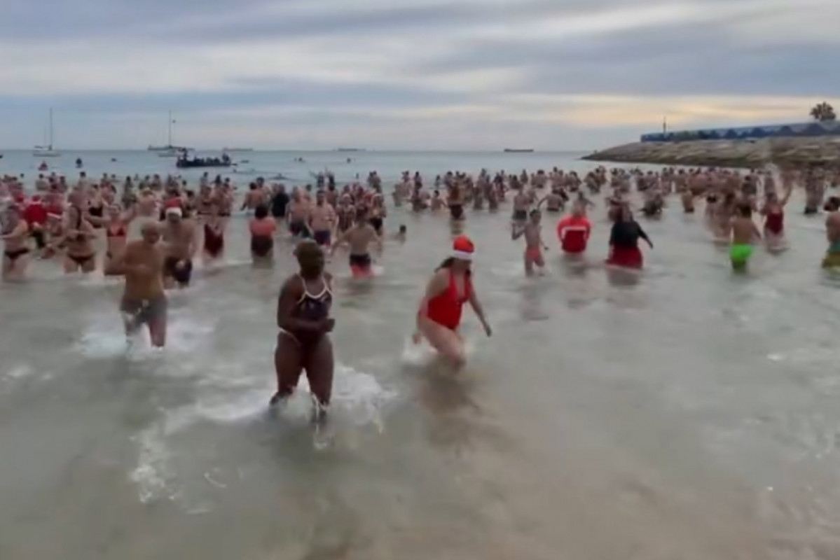 Personas bañándose en la Playa del Miracle de Tarragona este 31 de diciembre de 2024